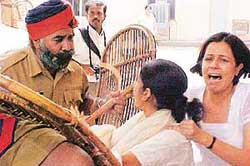 Two women run into the police wall during a lathi charge