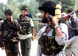 Members of a pro-India militant group Ikhwan patrol near their camp