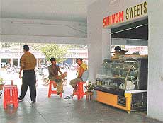 A sweetshop owner opens an illegal door of his shop 