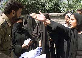 A woman activist of the APHC argues with a police officer