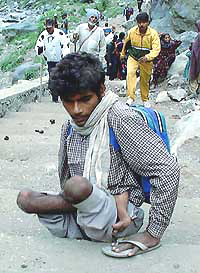A physically challenged pilgrim on way to the holy cave shrine 