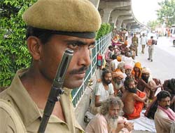 A jawan of the paramilitary force stands guard near pilgrims