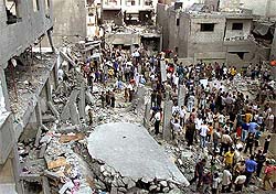 Palestinians inspect the damage to their houses after an Israeli missile strike in the Gaza Strip.