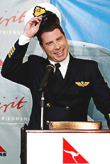US actor John Travolta takes off a pilot's hat upon his arrival