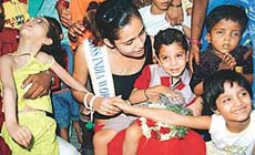 Femina Miss India World Shruti Sharma interacts with physically-challenged children at Prayaas