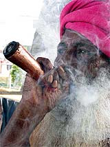 A sadhu enjoys a puff of ganza