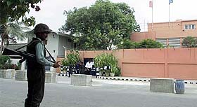 A Pakistani soldier stands guard in front of the closed French consulate