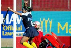 Indias Pritam Siwach celebrates after team-mate Saini Bala scored on Canadian goalkeeper 