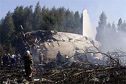 Russian emergency workers examine the wreckage of a Russian Ilyushin Il-86 passenger plane belonging to Pulkovo Airline that crashed on take off from Moscow airport on Sunday.