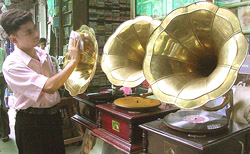 Indian shop owner Sheikh Mohammad Danish Afzal polishes an antique gramophone