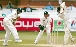 Indian batsman Ajit Agarkar hits a ball past England wicketkeeper Alec Stewart