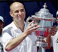 Andre Agassi holds the championship trophy after defeating Jan-Michael Gambill