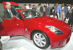 Car enthusiasts check out Nissan Motor Cos new Z sports car priced at 30,00000 yen ($25,000) in Tokyo on Tuesday.