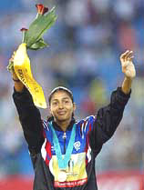 Indias Anju Bobby George, bronze medallist, waves during the medal ceremony