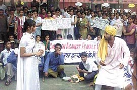Students and teachers of Delhi University and other educational institutions campaign against female foeticide through a street play in the Capital 