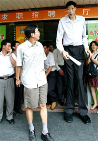 An unusually tall man walks out of an employment agency