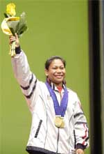 Indias Sanamacha Chanu poses with her three gold medals