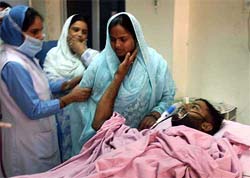 Md Rafik, a police man who was injured during gun battle, encourages his wife