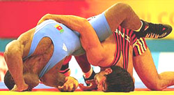 Indias Anuj Kumar bouts with Cameroons Jules Kamdem in their mens 84 kg wrestling heat at the 2002 Commonwealth Games