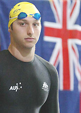 Australias Ian Thorpe stands by a Australian flag 