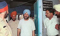 Suspended PPSC Chairman Ravi Sidhu being taken out of the Civil Judge-cum-Judicial Magistrates court in Chandigarh.