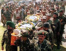 Army men carry the body of one of their jawans killed in an encounter with militants at Dalri forests near Watergam in north Kashmir on Sunday.