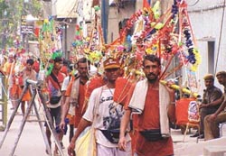 Kanwarias marching through a street of Delhi