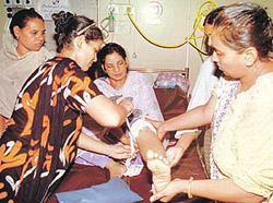 Paramedics treat a woman injured in a grenade attack in a Presbyterian hospital in Taxila, 40 km northwest of Islamabad, on Friday.