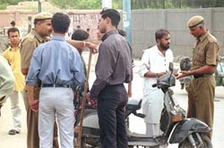 Policemen checking vehicles in the Seelampur area
