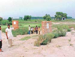 A villager of Mandiala points towards foundation stones
