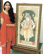 Prerna with her Tanjore paintings on satin glass.
