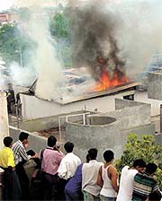 Firemen try to douse the flames at Jagdish Store in Lajpat Nagar in the Capital on Tuesday.