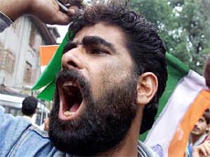 An activist belonging to the All Jammu Kashmir Peace Council, shouts anti-Pakistan slogans
