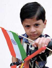 A child waves the tricolour on the eve of Independence Day 