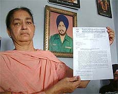 Ms Rajinder Kaur Aujla, widow of Major Didar Singh, shows the allotment letter