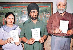 (From left) Ms Aman Sidhu, Mr Inderjit Singh Jaijee and Dr Gurmit Singh release booklet "Debt Trap --- Don’t Kill Yourself, Don’t Sell Your Land, Go to the Court" in Chandigarh on Sunday.