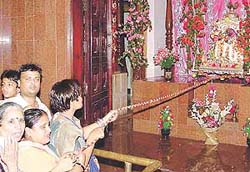 ISKCON devotees give a swing to Lord Krishna and his consort Radha on the occasion of "Jhulan yatra" at Hare Krishna Dham, Sector 36, Chandigarh, on Sunday.