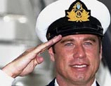 US actor John Travolta poses for photographs