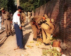 Police Personnel inspecting the spot of the Killing