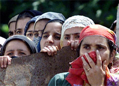 Local Kashmiri women watch an election rally