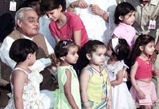Schoolchildren surround Prime Minister Atal Behari Vajpayee