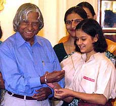 A Schoolgirl ties rakhee on President A.P.J. Abdul Kalam's hand
