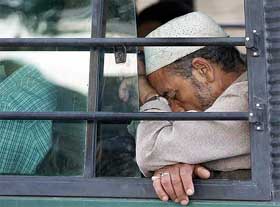 A man rests in a bus