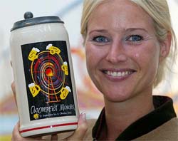 Sabine Kaefer, daughter of the publican, presents the official Oktoberfest beer mug