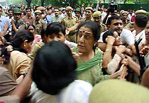 Furious Congress General Secretary Ambika Soni tries to break the police cordon during a scuffle between BJP Mahila Morcha and their Congress counterpart outside Congress President Sonia Gandhis residence 