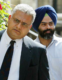 Journalists Paul Samrai and Ajit Singh arrive at the offices of the General Medical Council in London on Wednesday.