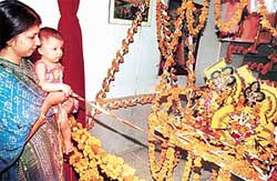 A mother and her child rock the ‘jhoola’ during Janamashtami celebrations