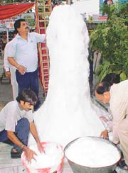 Devotees build an icicle at the entrance to Durga Mata Temple