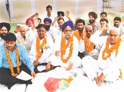 Members of the Punjab Colonisers and Property Dealers Association sit on a fast outside the District Commissioner's office