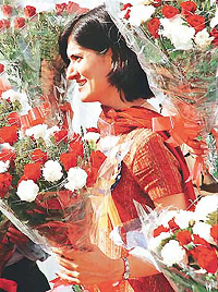 A law officer, holding a bouquet waits at the Haryana Advocate-Generals office for Union Law Minister K. Jana Krishnamurthy